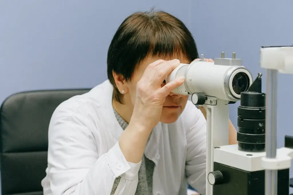 Woman in White Dress Shirt Using White Microscope